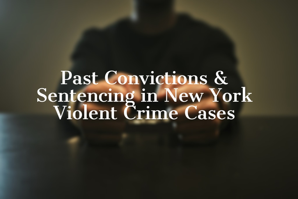 Text overlay reading 'Past Convictions & Sentencing in New York Violent Crime Cases' on a blurred image of a person with handcuffed hands on a table, directly representing the article's focus on how criminal history impacts sentencing.